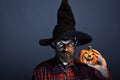 Halloween wizard hipster with beard and jack o lantern