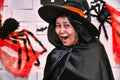 Senior woman in witch costumes celebrating Halloween laughing close up