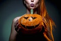 Halloween, woman in underwear with pumpkin in his hands. Portrait on dark green background.