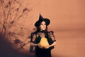 Halloween Woman in Witch Costume Holding Pumpkin