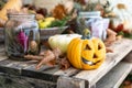 Hallowen jack o lantern and other autumn decorations on a wooden table