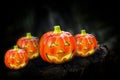Hallowen pumpkins with shining eyeson the wooden block