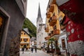 Hallstatt, Austria, 27 August 2021: Colorful scenic picturesque town street at summer day, mountain village near lake, Alps,