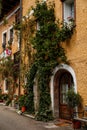 Hallstatt, Austria, 27 August 2021: Colorful scenic picturesque town street at summer day, oval wooden door, braided window, green Royalty Free Stock Photo