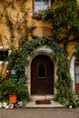 Hallstatt, Austria, 27 August 2021: Colorful scenic picturesque town street at summer day, oval wooden door, braided window, green Royalty Free Stock Photo