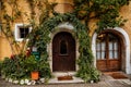 Hallstatt, Austria, 27 August 2021: Colorful scenic picturesque town street at summer day, oval wooden door, braided window, green Royalty Free Stock Photo