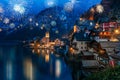 Hallstatt in Austria celebrating New Years Eve with flashing colorful firework