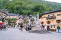 17.07.2020 Hallstatt. Austria. Central Square with flowers and historical architecture in Austria Alps mountain. Tourists walk in Royalty Free Stock Photo