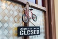 HALLSTATT, AUSTRIA - DECEMBER 2018: door signboard saying Sorry we are closed with toy bicycle above