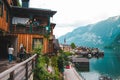 Hallstatt, Austria - June 15, 2019: elder people talking from the balcony with young couple