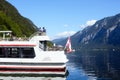 Hallstatt, Austria, September 2019. Famous mountain village in the Austrian Alps on a warm autumn day. Pleasure boat on the lake. Royalty Free Stock Photo