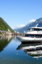 Hallstatt, Austria, September 2019. Famous mountain village in the Austrian Alps on a warm autumn day. Pleasure boat on the lake. Royalty Free Stock Photo