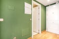 Hallway in an apartment with plain green painted walls