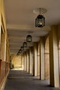 hallway with arches and lighted ceiling lamps