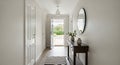 Hallway with Console Table, Mirror, and Open Door Royalty Free Stock Photo
