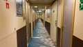 A hallway on a cruise ship with blue geometric patterned carpet