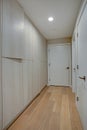 Hallway features ivory cabinets and taupe walls