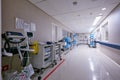 The hallway of healing. Shot of an empty passage way with medical equipment alongside the walls at a hospital. Royalty Free Stock Photo