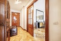 Hallway of a house with varnished French oak hardwood floors and sapele wood room doors with beveled windows Royalty Free Stock Photo