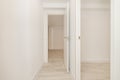 Hallway of a house with white wooden doors, wood-like stonewar