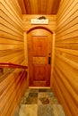 Hallway interior with pannel wooden trim. Door to home wine cellar.