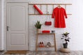 Hallway interior with furniture, shoes and plants