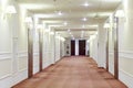 Hallway with many doors leading into hotel rooms. Royalty Free Stock Photo