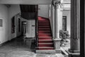 The hallway and staircase laid with red carpet