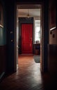 A hallway in a suburban home with a polished dark hardwood floor and a red front door. Royalty Free Stock Photo