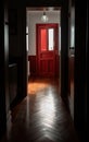 A hallway in a suburban home with a polished dark hardwood floor and a red front door Royalty Free Stock Photo