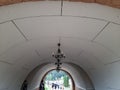 Hallway under the bridge. Pedestrian crosswalk under glass roof passage in urban environment.