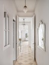 Hallway with vintage chandeliers overlooking a long corridor with many doors to the rooms. Royalty Free Stock Photo