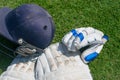 Halmet, cricket pad and gloves isolated on a green background. cricket safety equipments