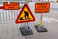 Halmstad, Sweden - August 20, 2022: Road works sign on city street and information board in Swedish language that directs cyclist