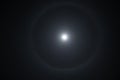 Halo around full moon. Super moon with a circular rainbow halo surrounded by stars