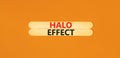 Halo effect and psychological symbol. Concept words Halo effect on beautiful wooden stick. Beautiful orange table orange