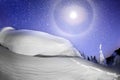 Halo and moon over a snow cornice Royalty Free Stock Photo