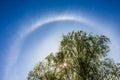 Halo - an optical phenomenon in the atmosphere, a bright colored ring around the Sun in the sky Royalty Free Stock Photo