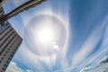 Halo sun in the clouds of cirrus on the city. Royalty Free Stock Photo