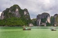 Halong Bay limestone cliffs with two traditional fishing boats, UNESCO world natural heritage, Vietnam Royalty Free Stock Photo