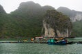 Halong Bay in mystical clouds. Traditional fishermens village in ther sea. Mystical atmoshpere in the world famous halong bay. Royalty Free Stock Photo