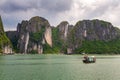 Halong Bay Rock formation with traditional green fishing boat, UNESCO world natural heritage, Vietnam