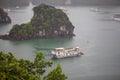 Halong bay traditional fishing boats, UNESCO world natural heritage, Vietnam. Tourist cruise ships sailing among limestone