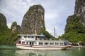 Halong bay traditional fishing boats, UNESCO world natural heritage, Vietnam. Tourist cruise ships sailing among limestone