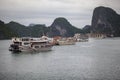 Halong bay traditional fishing boats, UNESCO world natural heritage, Vietnam. Tourist cruise ships sailing among limestone Royalty Free Stock Photo