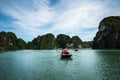 Halong bay in Vietnam, UNESCO World Heritage Site, with tourist rowing boats