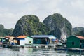 Halong, Vietnam - May 2019: Fishermen village floating among limestone mountains in Halong Bay