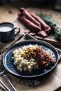 Halusky as traditional Slovak potato gnocchi with sheep cheese bryndza, fried bacon,sausage and chives Royalty Free Stock Photo