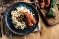 Halusky as traditional Slovak potato gnocchi with sheep cheese bryndza, fried bacon,sausage and chives Royalty Free Stock Photo