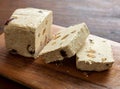 Halva almond nuts slices on wooden table background